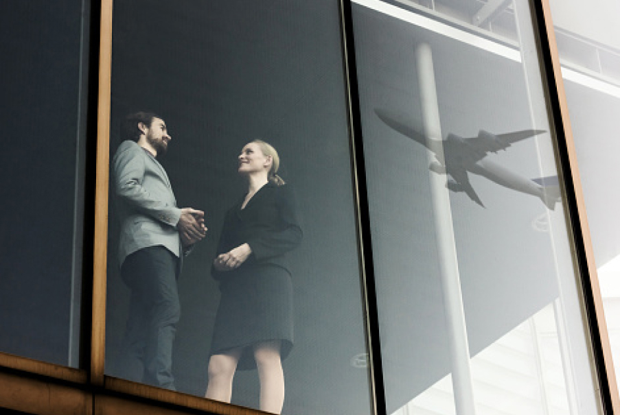 Man and lady talking at airport